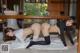 A couple of women laying on top of a white towel.