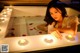 A woman laying in a bathtub with candles in it.